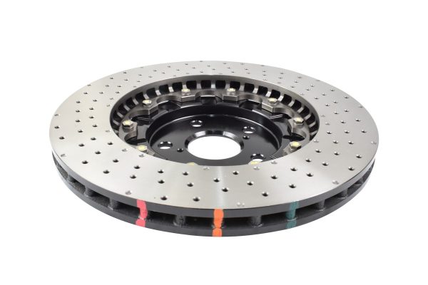 Cross-drilled and dimpled silver brake disc with black vented hub and colored heat-strip markings around the edge.